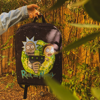 Backpack with cartoon design held by a person in a forest setting